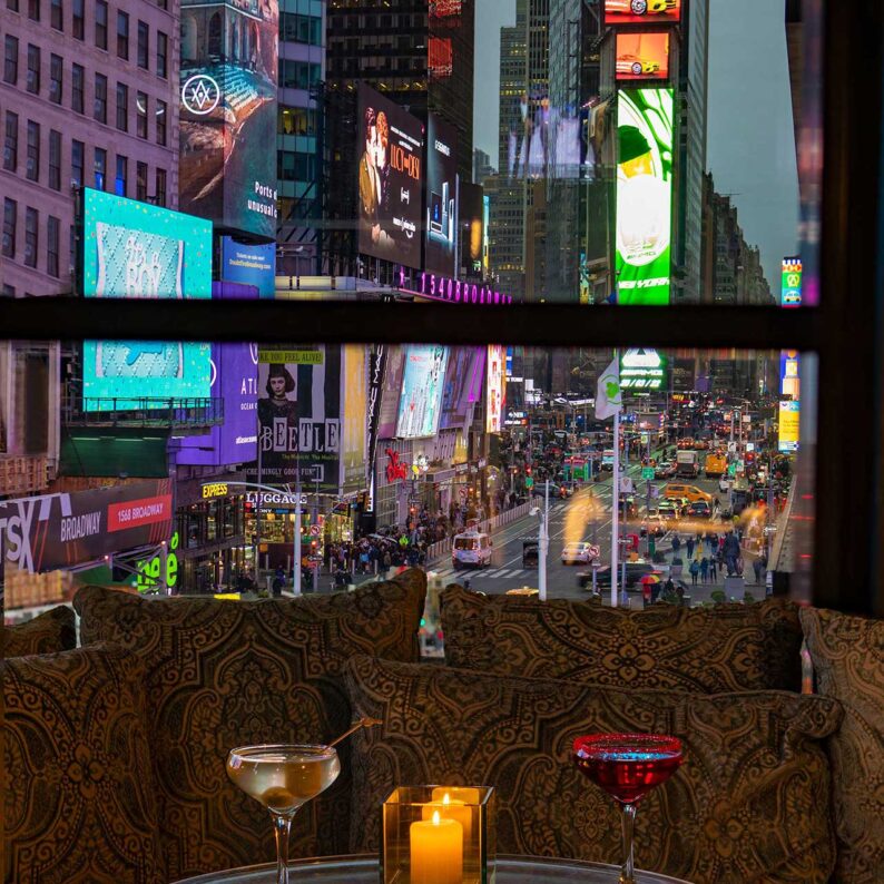 round table with cocktails and candle overlooking times square